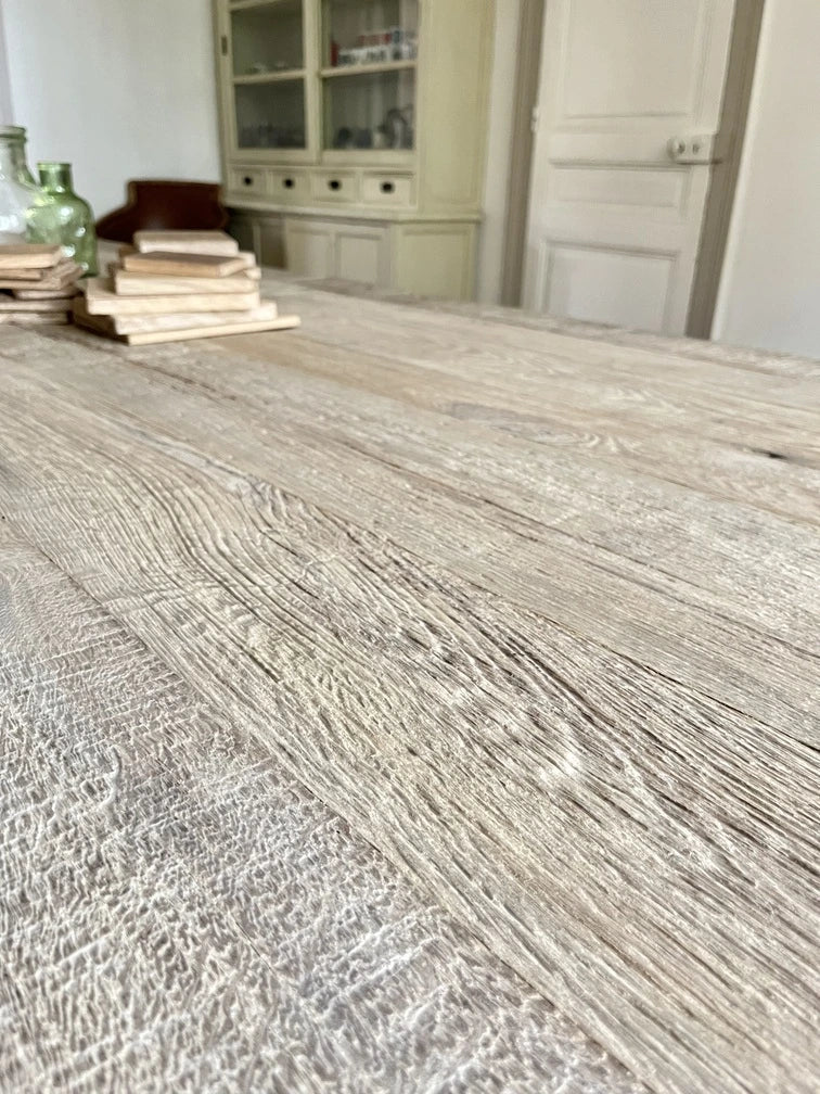 Texture du chêne massif ancien sur le plateau de la table Founder, finition brute artisanale.